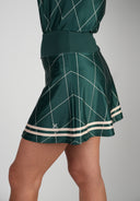 Pine Golf Skirt - Green with a stylish high-waisted fit and lightweight fabric. Features a geometric pattern and trim, offering comfort and mobility on the course.